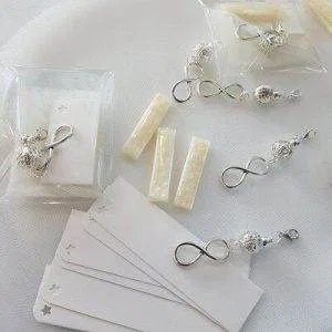 stock BOMBONIERE BATTESIMO CRESIMA COMUNIONE MATRIMONIO Infinito INFINITY CHARM